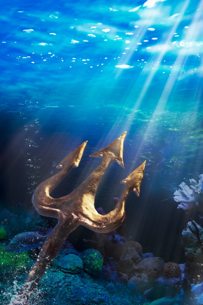 Underwater scape, with a gold trident in the foreground